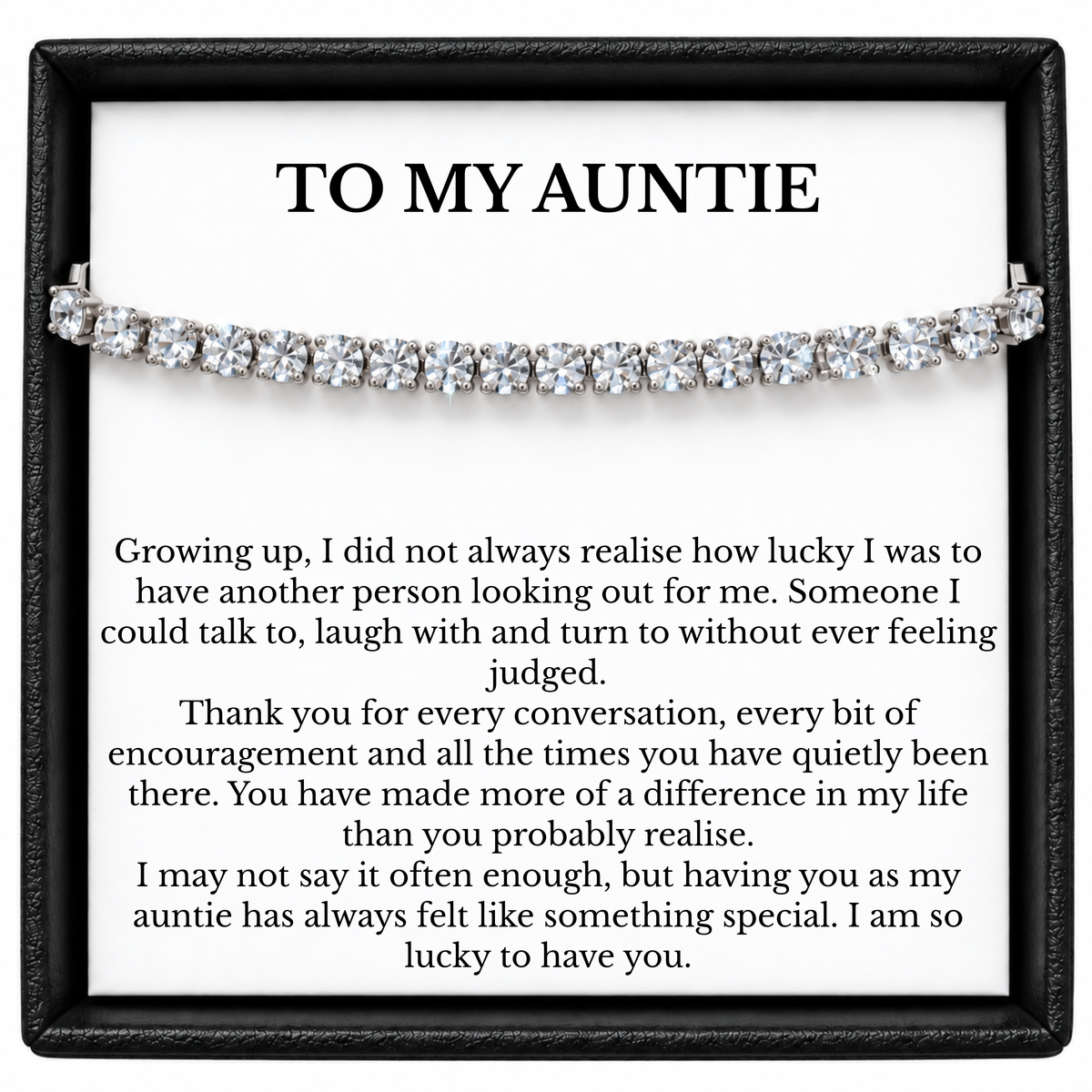 Tennis bracelet with clear stones displayed across a To My Auntie message card inside a black gift box.
