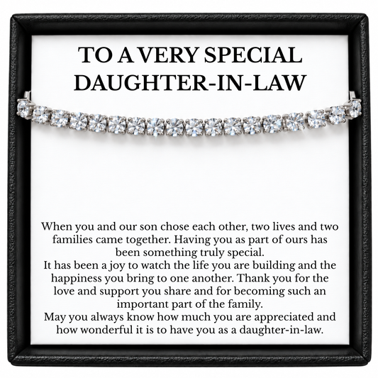 Silver-coloured tennis bracelet across a daughter-in-law message card in an open black gift box