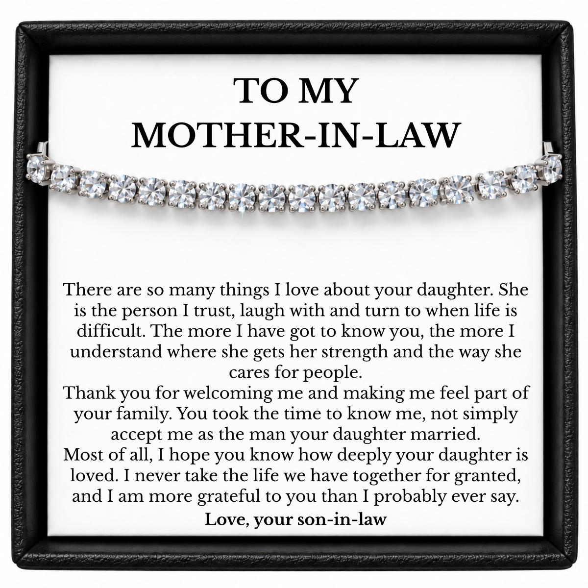 Silver-coloured tennis bracelet across a mother-in-law message card from her son-in-law in a black gift box.