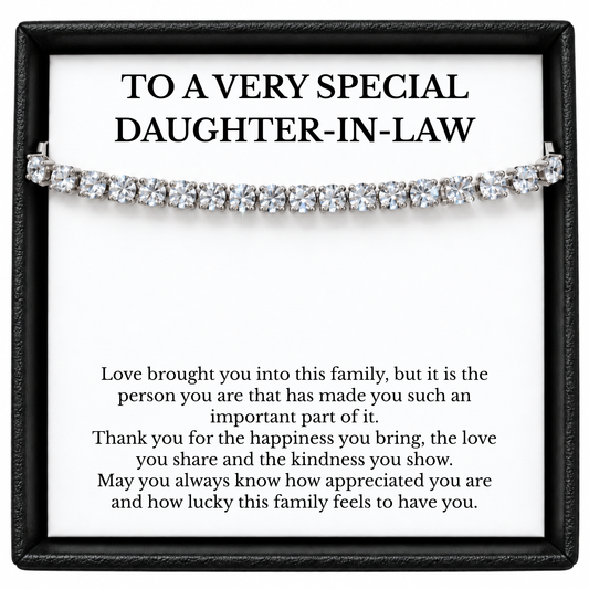Silver-tone tennis bracelet across a white daughter-in-law message card in a black gift box.