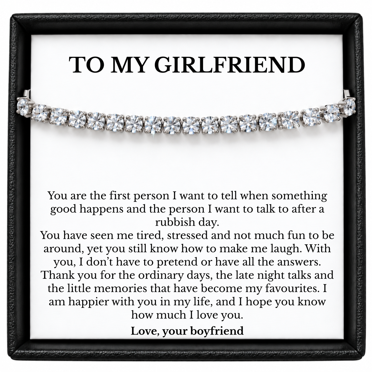 Silver colour tennis bracelet displayed across a To My Girlfriend message card from her boyfriend inside a black gift box.