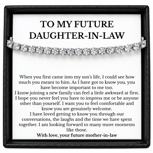 Tennis bracelet displayed over a future daughter-in-law message card from her future mother-in-law in a black gift box.