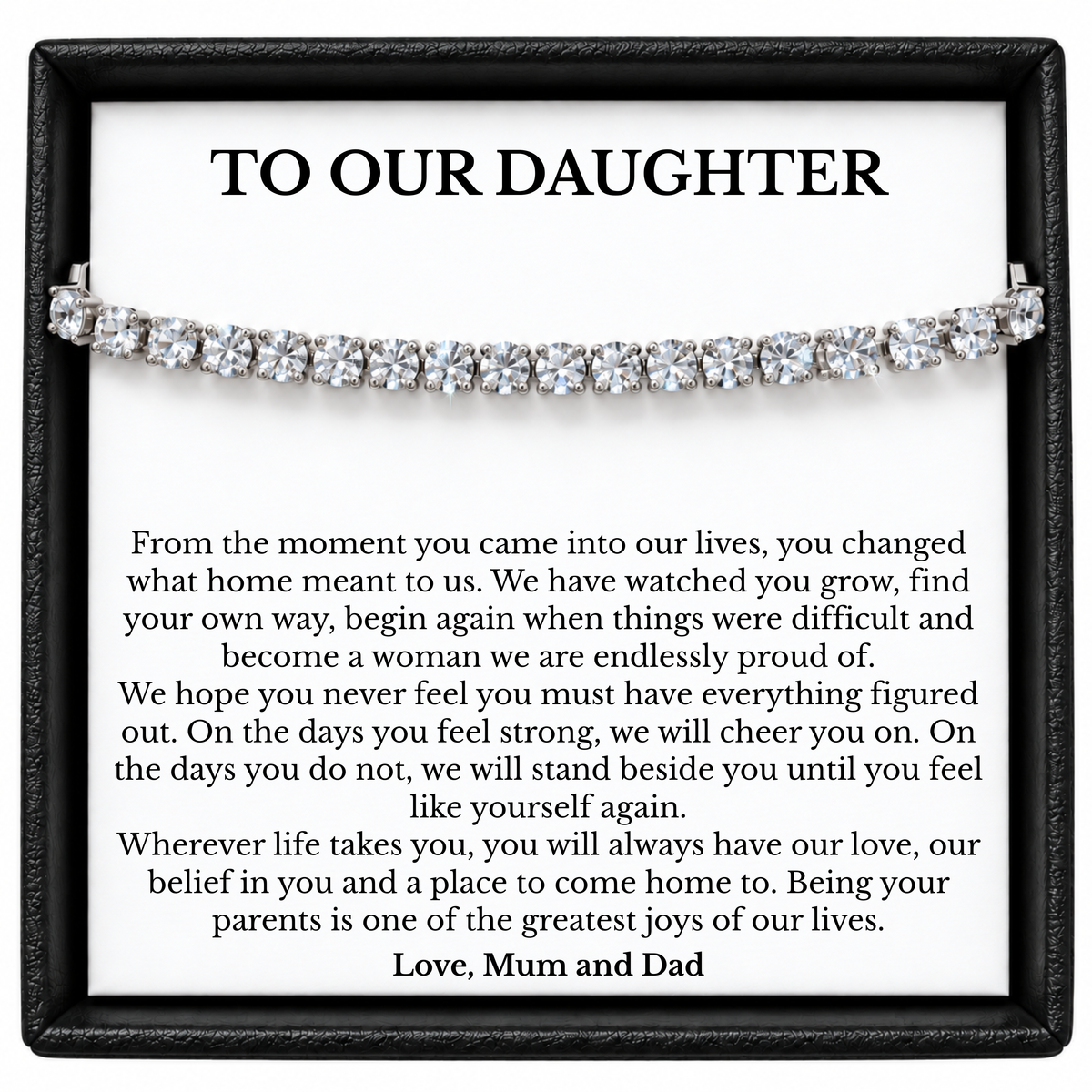 Silver-tone tennis bracelet across a To Our Daughter message card from Mum and Dad inside a black gift box