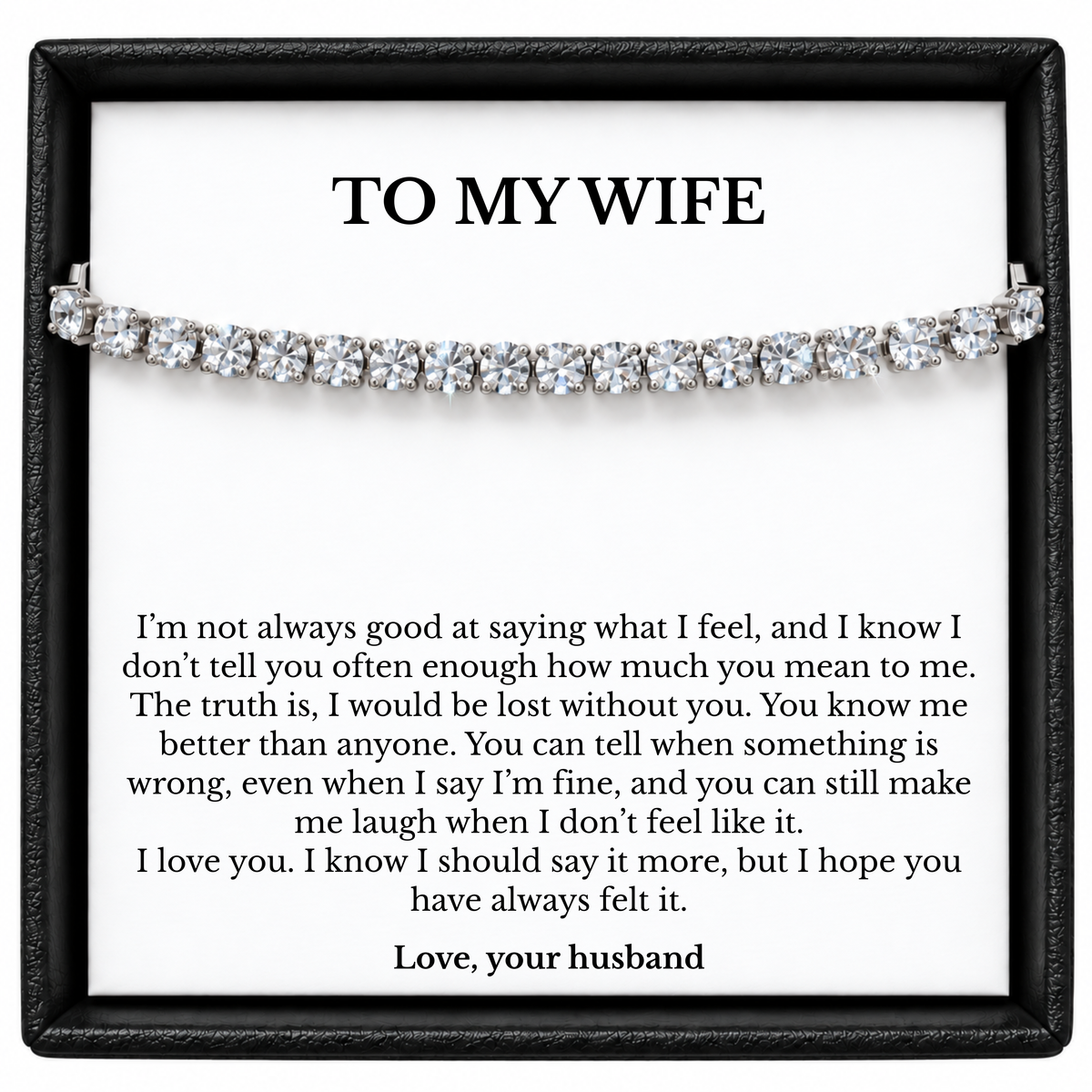 Silver-coloured tennis bracelet in a black gift box with a To My Wife message card signed Love, your husband