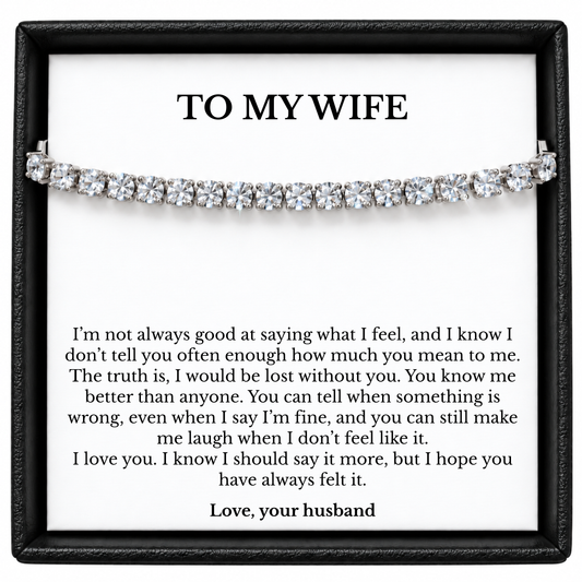 Silver-coloured tennis bracelet in a black gift box with a To My Wife message card signed Love, your husband