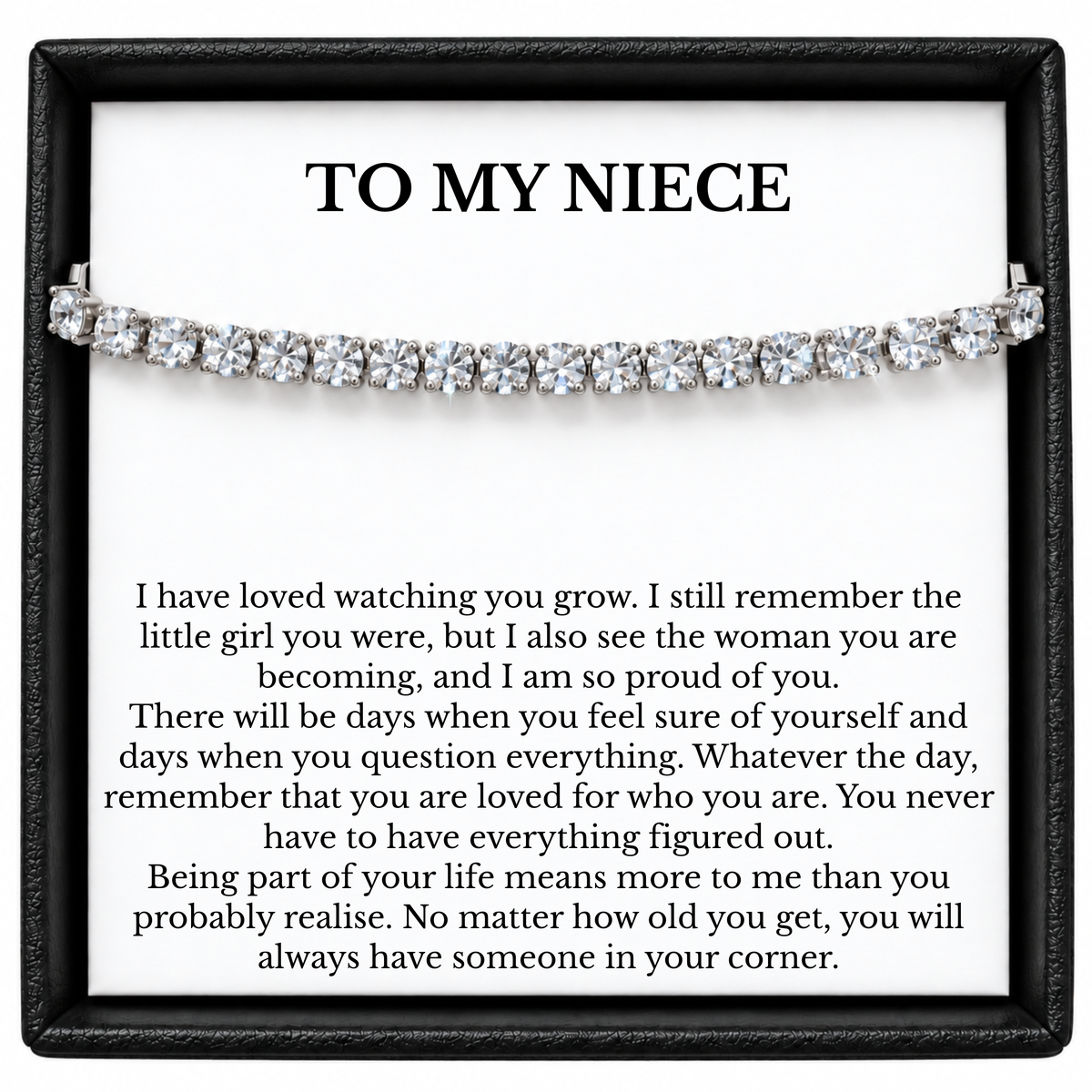 Silver-coloured tennis bracelet across a To My Niece message card inside a black gift box.