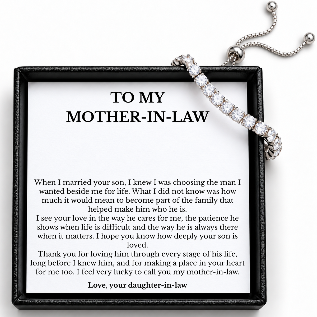 Mother-in-law tennis bracelet with its sliding adjuster and chain ends visible above the printed message card and black box.