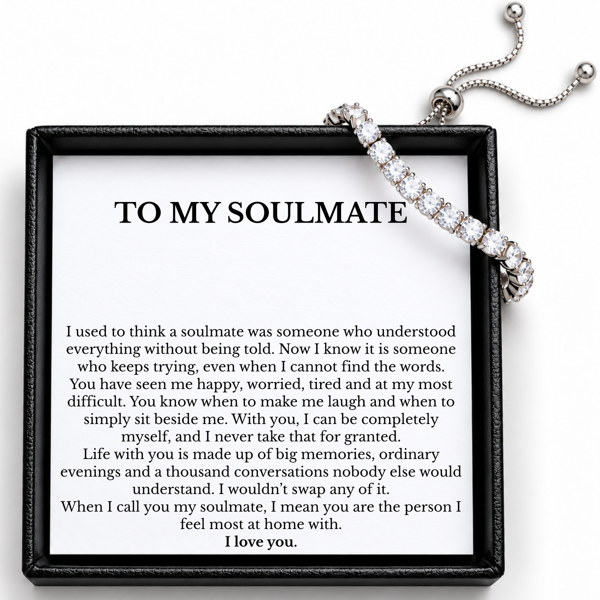 Soulmate tennis bracelet showing clear round stones, an adjustable slider and chain ends above the message card.