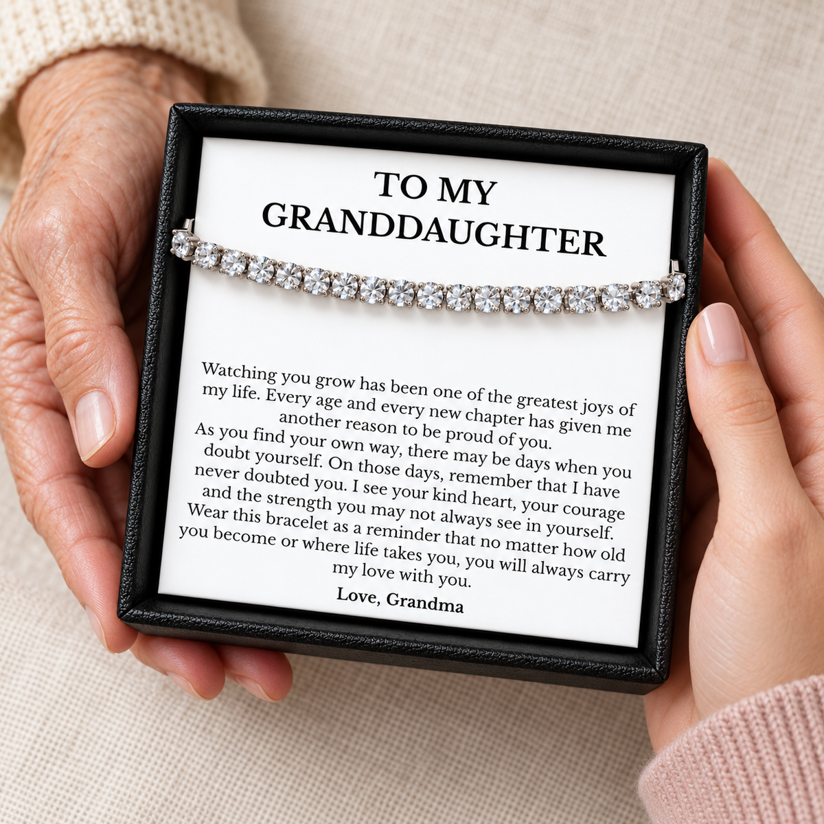 Grandma giving her granddaughter a boxed tennis bracelet with a heartfelt message of love and encouragement.