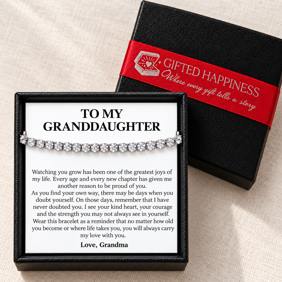 Granddaughter bracelet and message card from Grandma in a black gift box, beside its lid with red Gifted Happiness ribbon.
