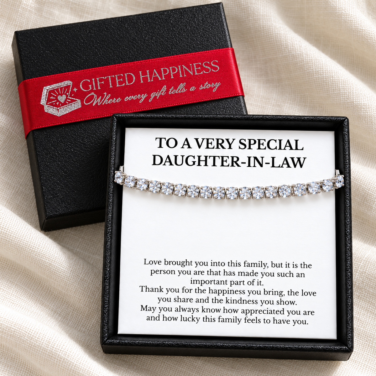 Daughter-in-law bracelet and message card in an open black gift box beside the lid with branded red ribbon.