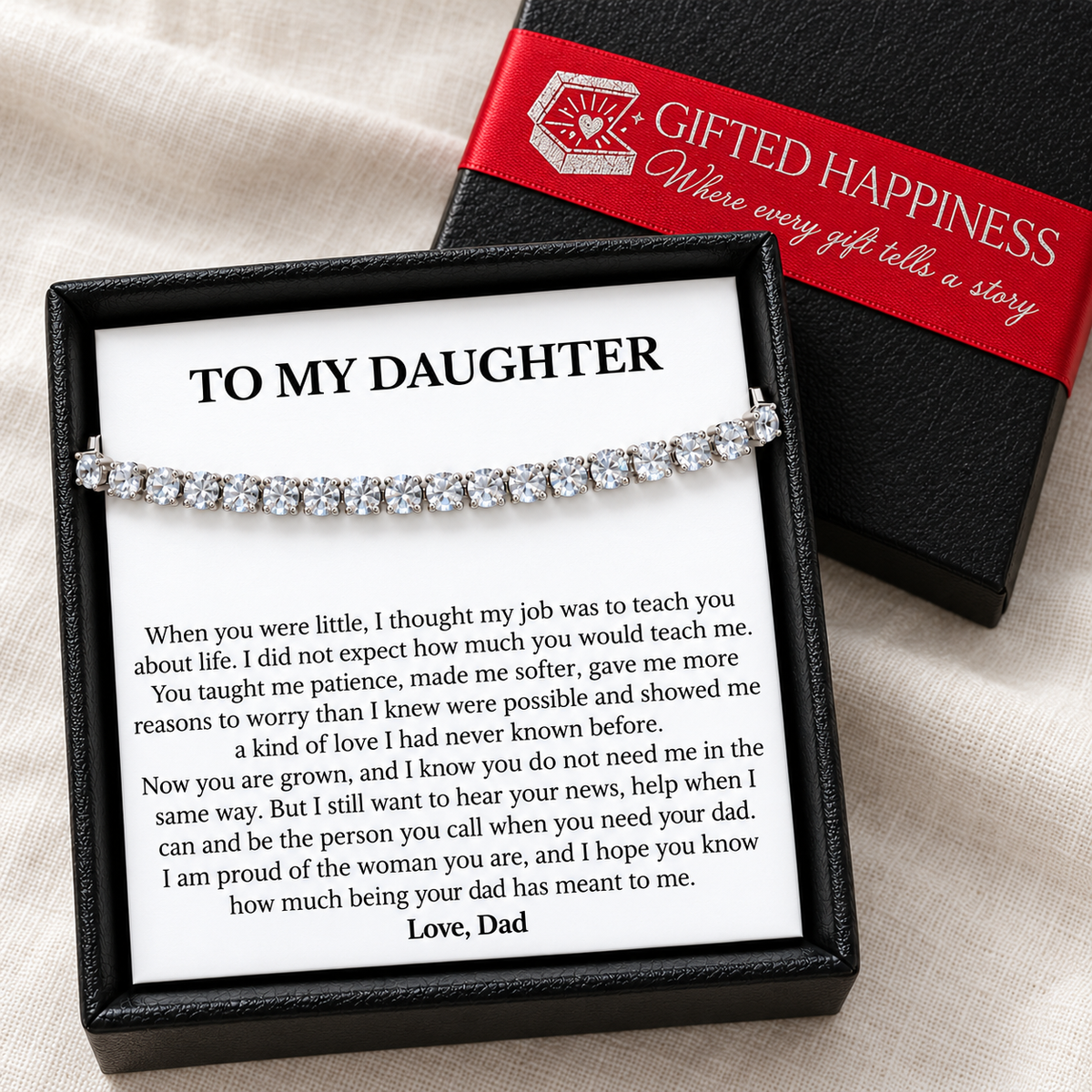Daughter bracelet and Love, Dad message card in an open black gift box beside its lid with red Gifted Happiness ribbon.