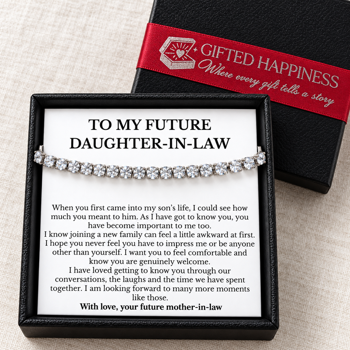 Future daughter-in-law bracelet and message card in a black gift box beside its lid with red Gifted Happiness ribbon.