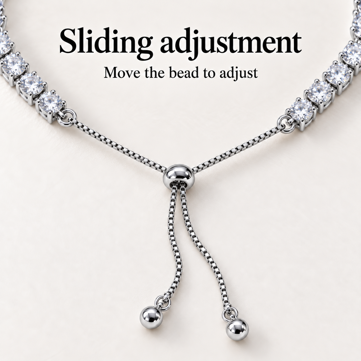 Close-up of the bracelet's sliding bead adjuster and two fine chains with rounded end beads.